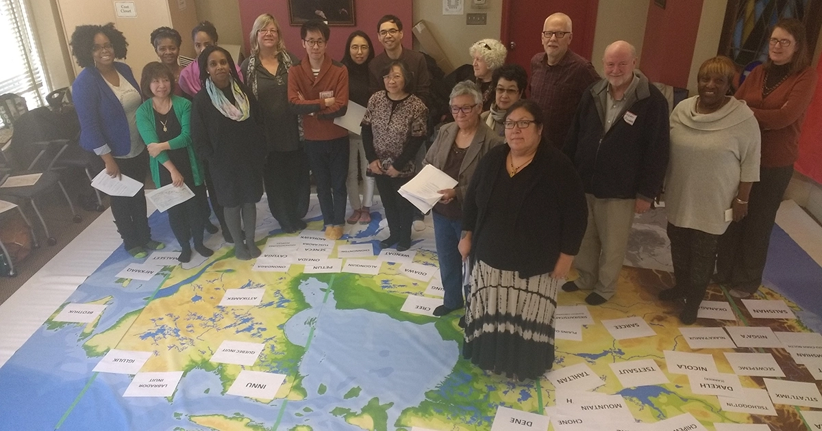 Participants in an Intercultural Ministry program organized by the Canadian Council of Churches stand on a map identifying the locations of various First Nations across Canada. Photo: CCC