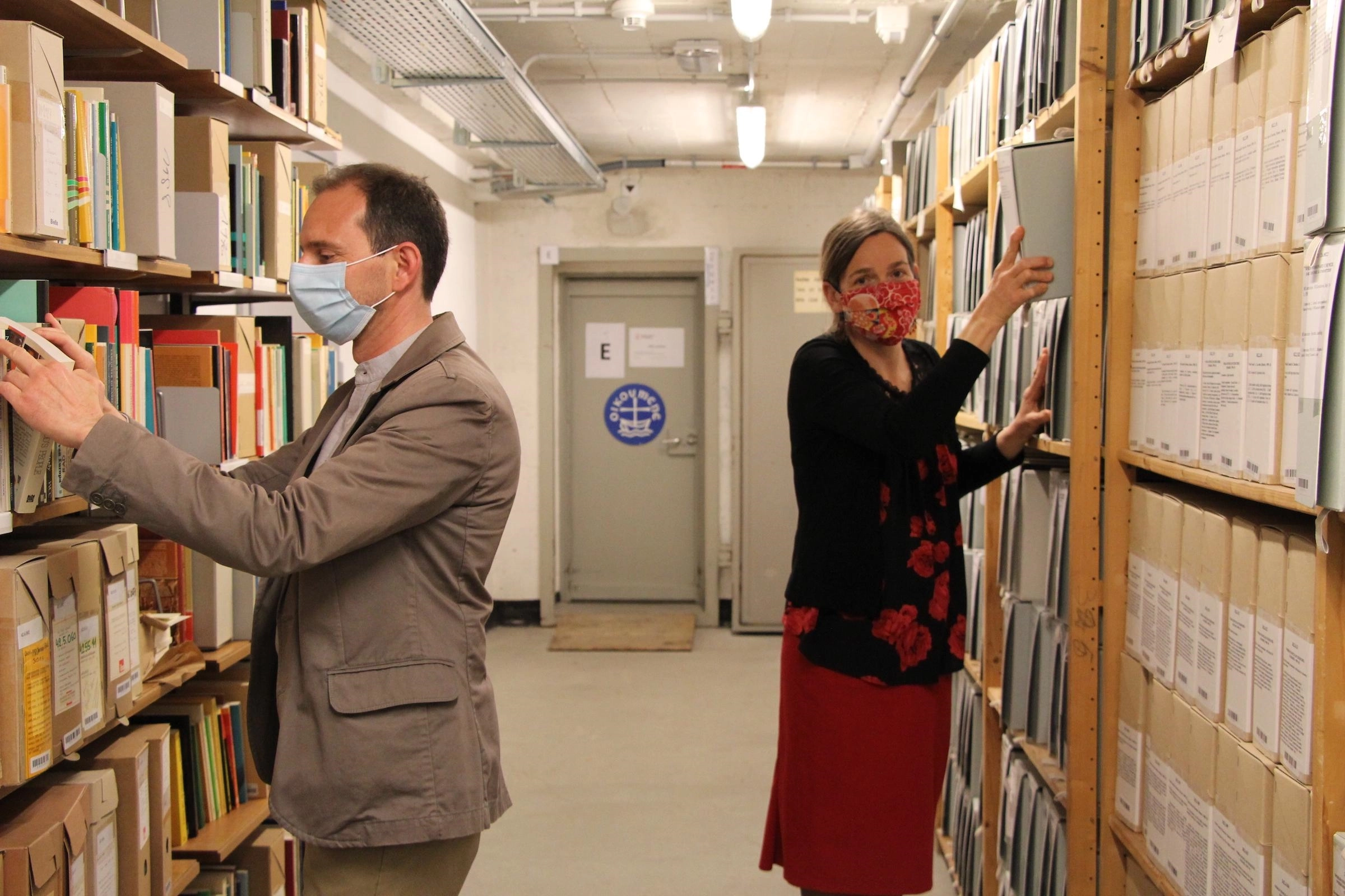 WCC Archivist Anne-Emmanuelle Tankam-Tene (right) and librarian Pedro Nari (left) work on arranging library material