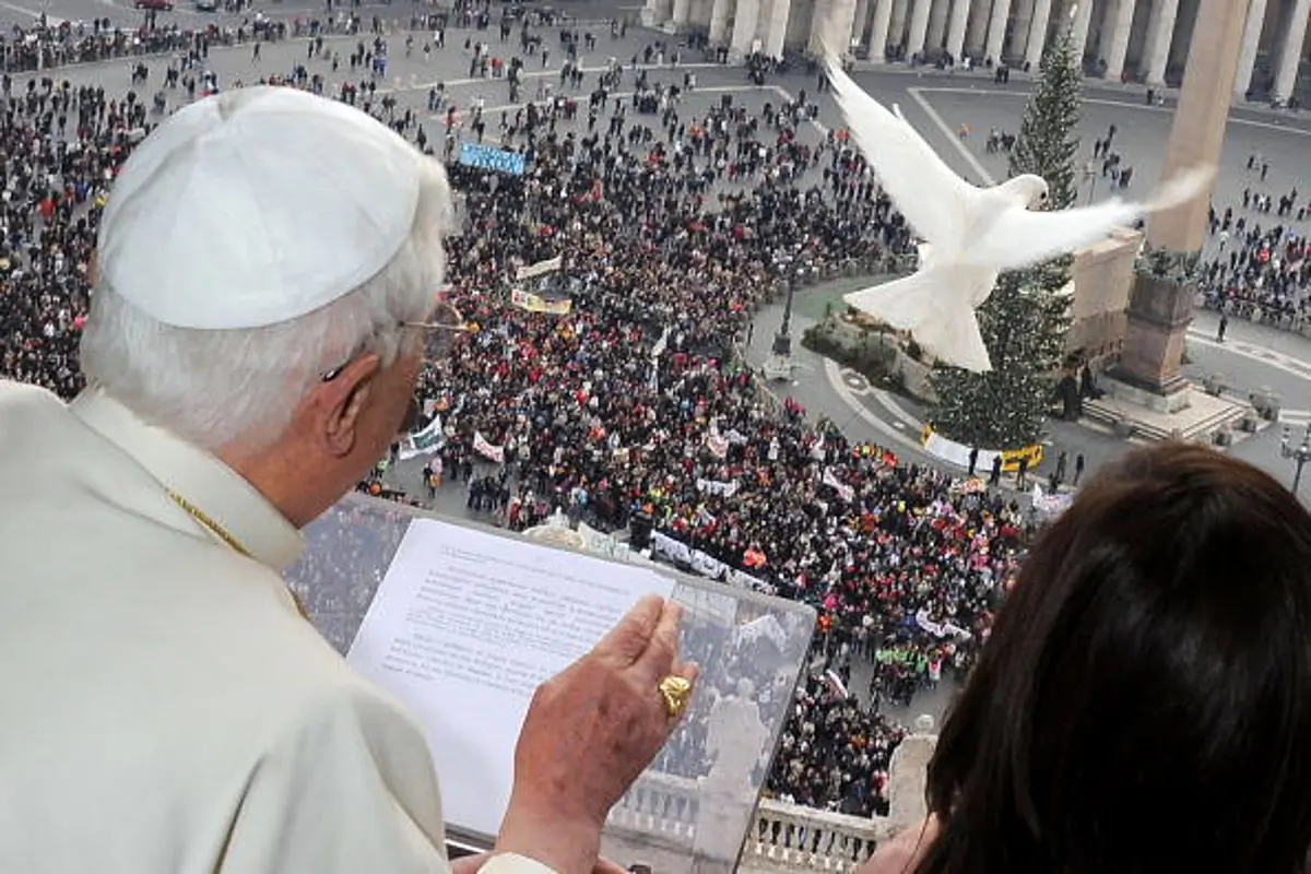 In this file photo, Pope Benedict XVI and children release doves from a window in the Apostolic Palace overlooking St. Peter's Square