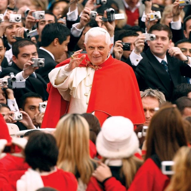 Pilgrims have their cameras ready as Pope Benedict XVI makes his way through the crowd in St. Peter’s Square at the Vatican before a general audience