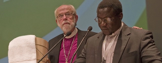 Mennonite World Conference President Danisa Ndlovu of Zimbabwe [right], presented Lutheran World Federation (LWF) President Bishop Mark. S. Hanson with a pine foot-washing tub as a sign of commitment to a future 'when the distinguishing mark of Lutheran and Anabaptist-Mennonite relationships is boundless love and unfailing service'