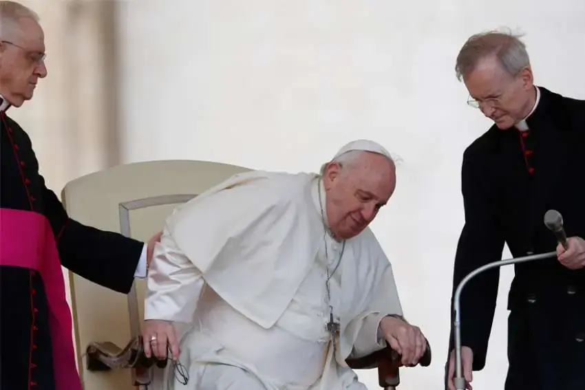 Pope Francis grimaces in pain as he gets up from his chair during the general audience in St. Peter's Square at the Vatican in this April 20, 2022, file photo. On his doctors' advice because of ongoing problems with his knee, the pope will not travel to Congo and South Sudan in early July, the Vatican announced