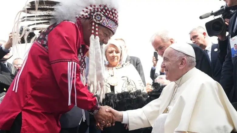 Pope Francis is greeted by George Arcand, Grand Chief of the Confederacy of Treaty Six First Nations, as he arrives in Edmonton on Sunday. His visit to Canada is aimed at reconciliation with Indigenous people for the Catholic Church's role in residential schools