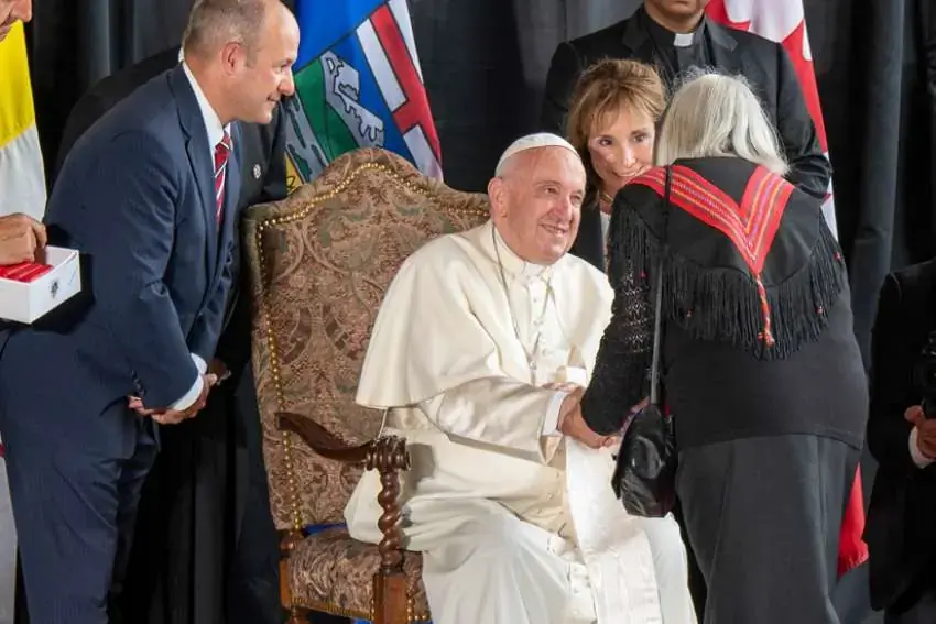 Pope Francis is greeted by a Métis representative during the formal arrival ceremony at the Edmonton airport