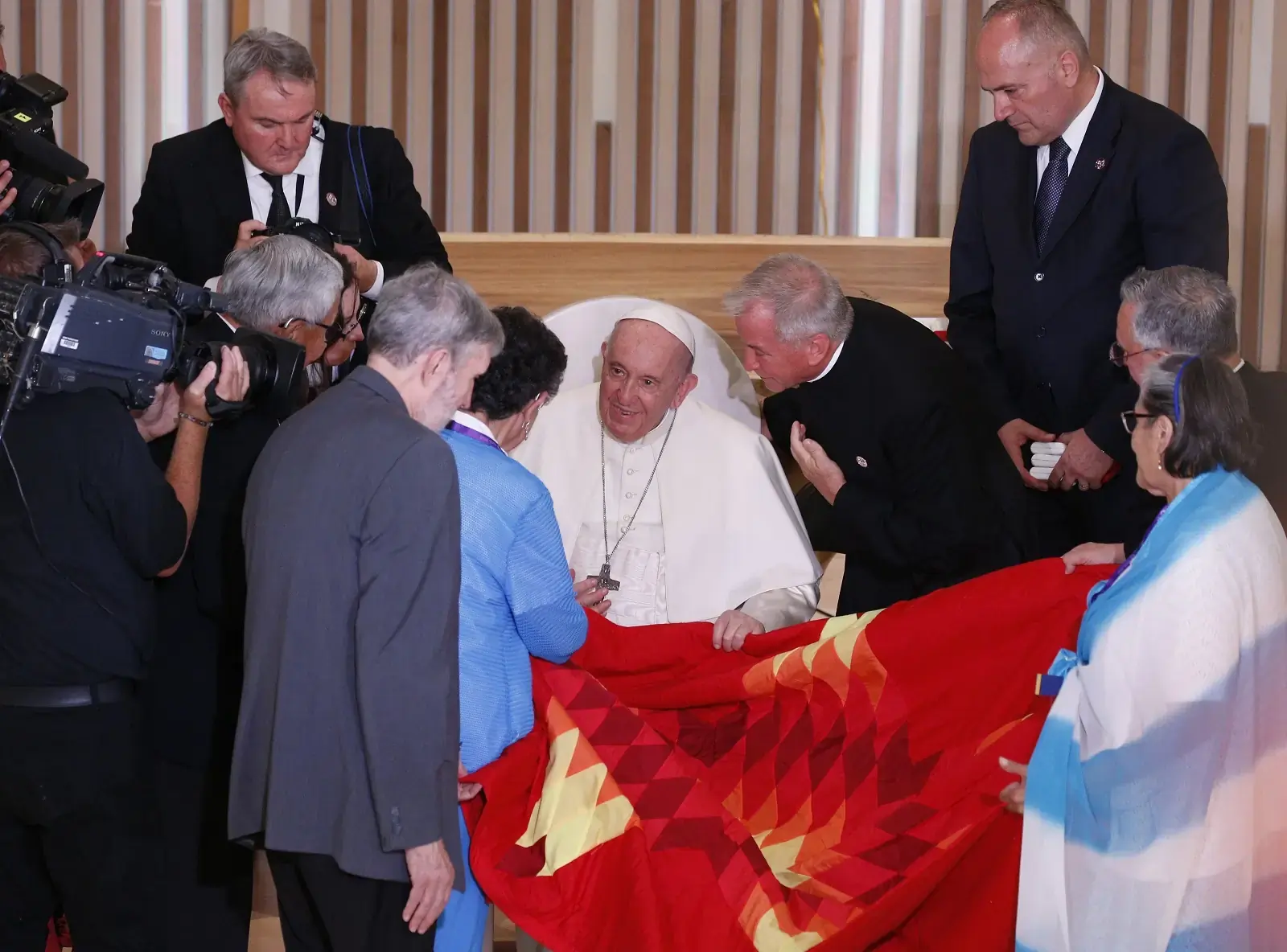 Pope Francis receives a Star Blanket during a meeting with Indigenous peoples and members of the parish community of Sacred Heart Church of the First Peoples in Edmonton, Alberta