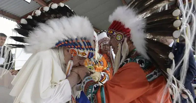 Pope Francis wearing a headdress presented to him by Chief Wilton Littlechild at Maskwacis First Nation during the pope's pilgrimage of reconciliation with Indigenous peoples