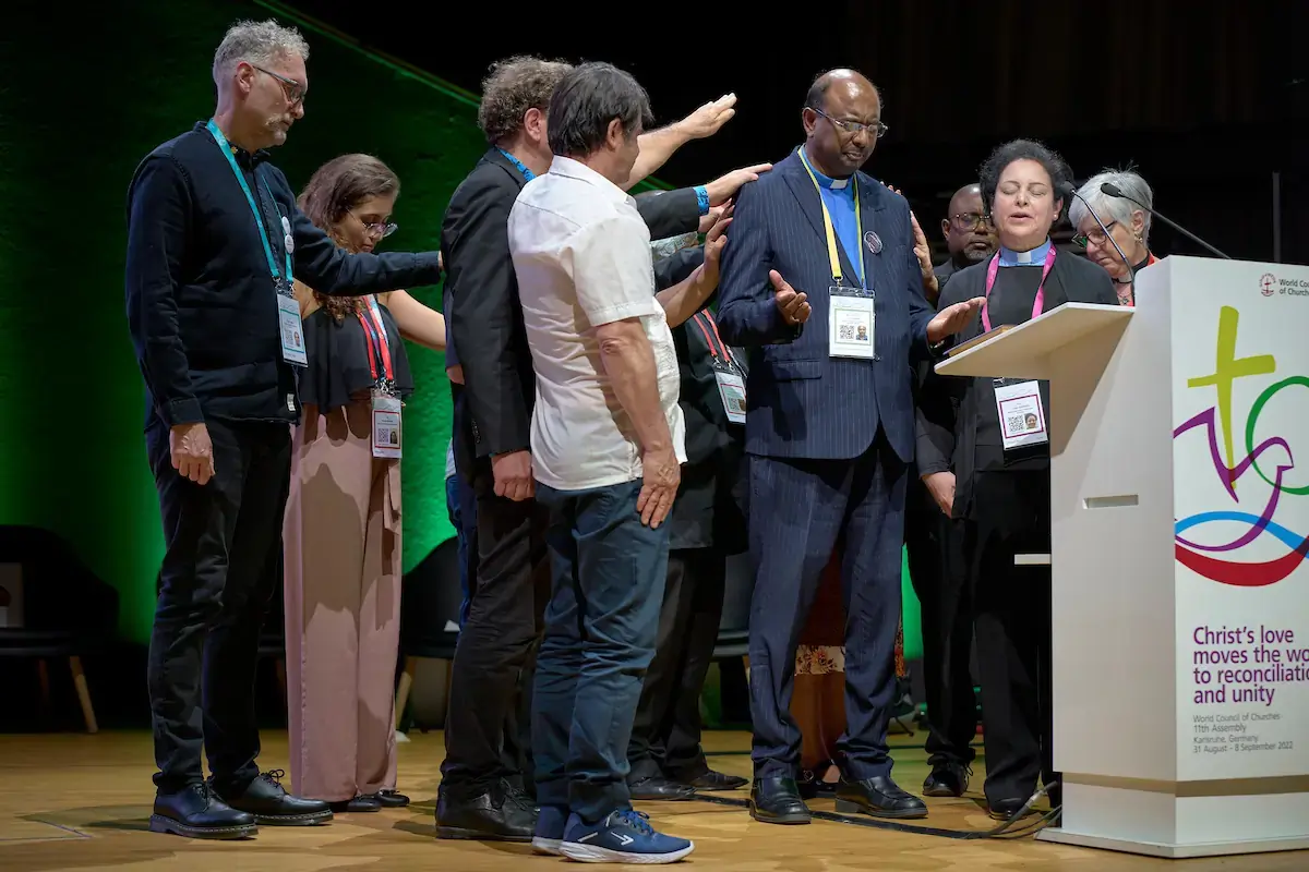 The Rev. Dr. Jerry Pillay, a former president of the World Communion of Reformed Churches who will become the next WCC general secretary in January 2023, is blessed by leaders of the Reformed community during a confessional gathering at the 11th Assembly of the WCC, held in Karlsruhe, Germany. The Assembly's theme is 'Christ's Love Moves the World to Reconciliation and Unity'