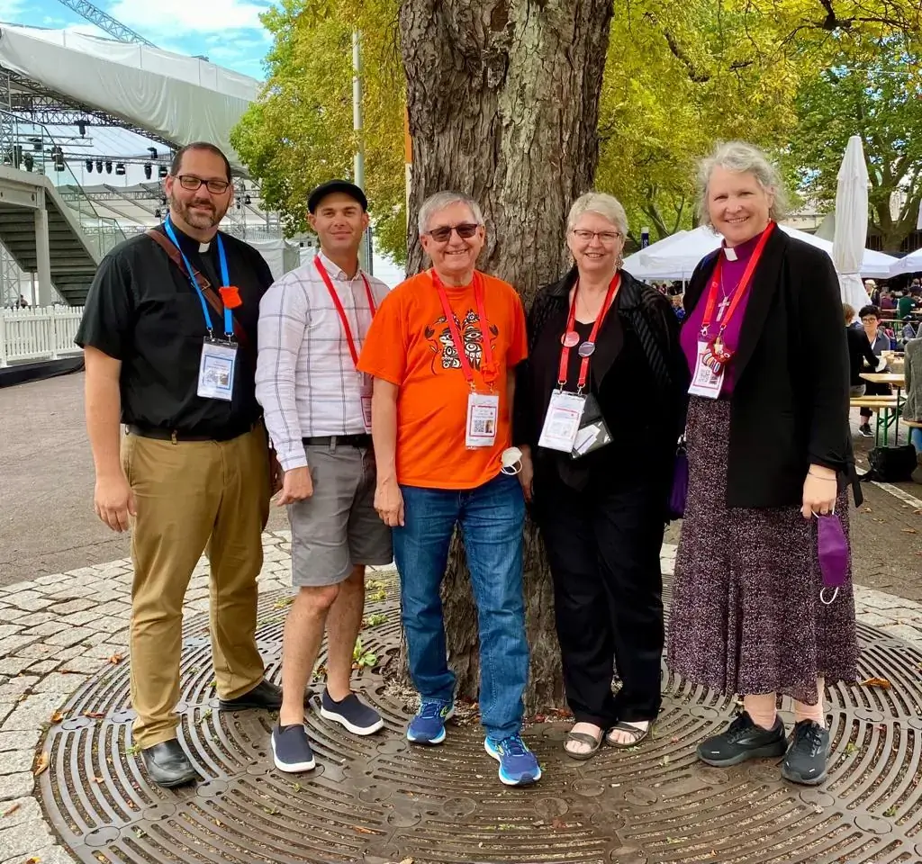 Canadian Anglican delegates to the WCC Assembly pose for a photo on the streets of Karlsruhe. From left to right: Canon Scott Sharman, Brendon Neilson, Canon Murray Still, the Rev. Cynthia Haines-Turner, and Rt. Rev. Riscylla Shaw, bishop of Trent-Durham in the diocese of Toronto