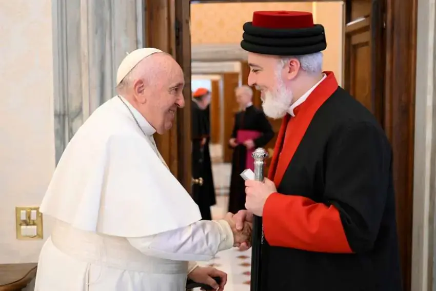 Pope Francis shakes hands with Catholicos Awa III, patriarch of the Assyrian Church of the East, at the end of a meeting in the library of the Apostolic Palace at the Vatican