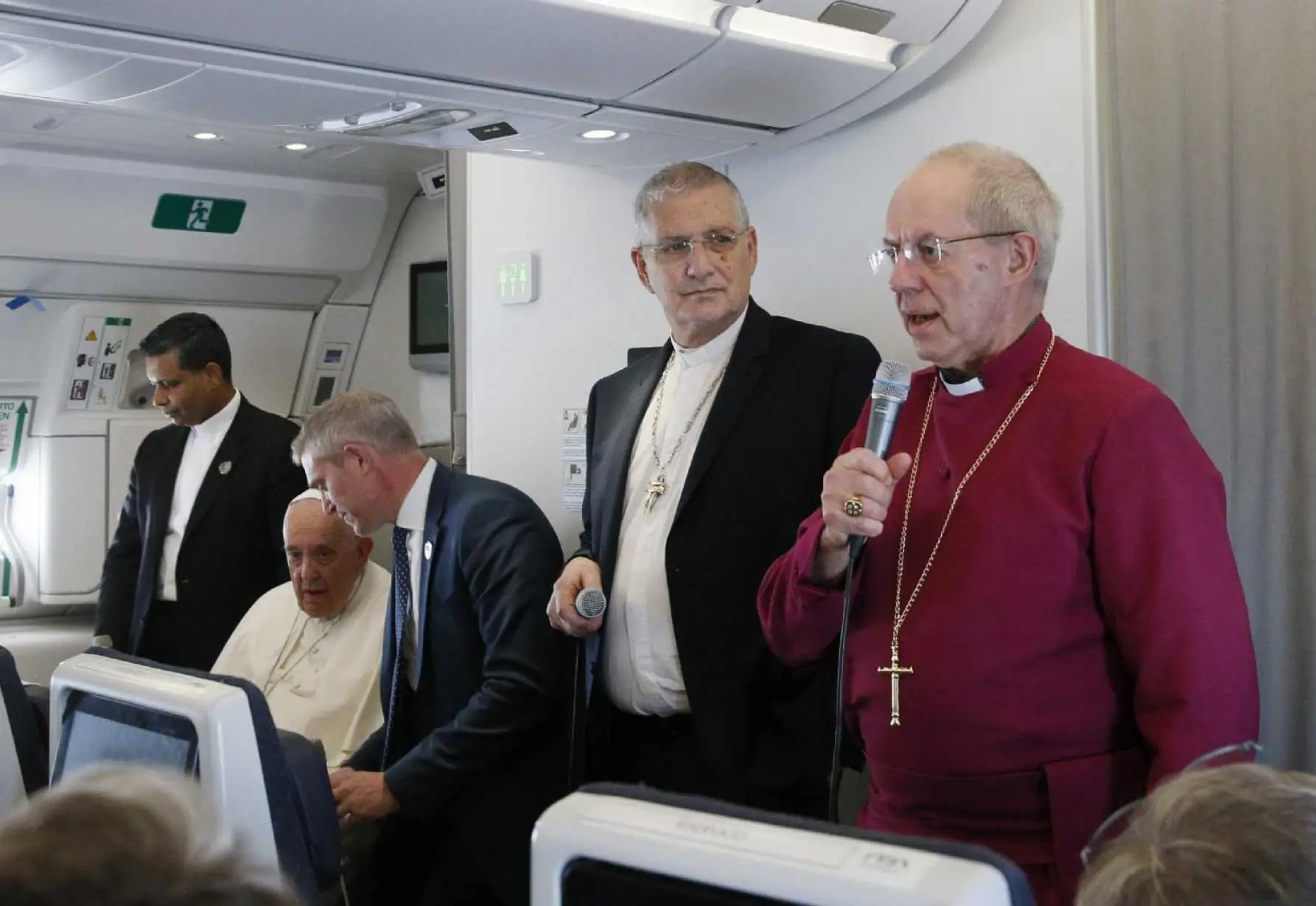 Anglican Archbishop Justin Welby, right, stands by Rev. Iain Greenshields, moderator of the Presbyterian Church of Scotland, and Pope Francis as he speaks to journalists aboard the flight from Juba, South Sudan, to Rome
